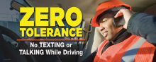 Large-format fleet safety banner featuring bold warning graphics and text stating "Zero Tolerance – No Texting or Talking While Driving".