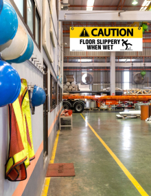Caution Floor Slippery When Wet ceiling sign printed on 4mm corrugated plastic with nickel grommets and grid clips for suspended ceiling mounting.